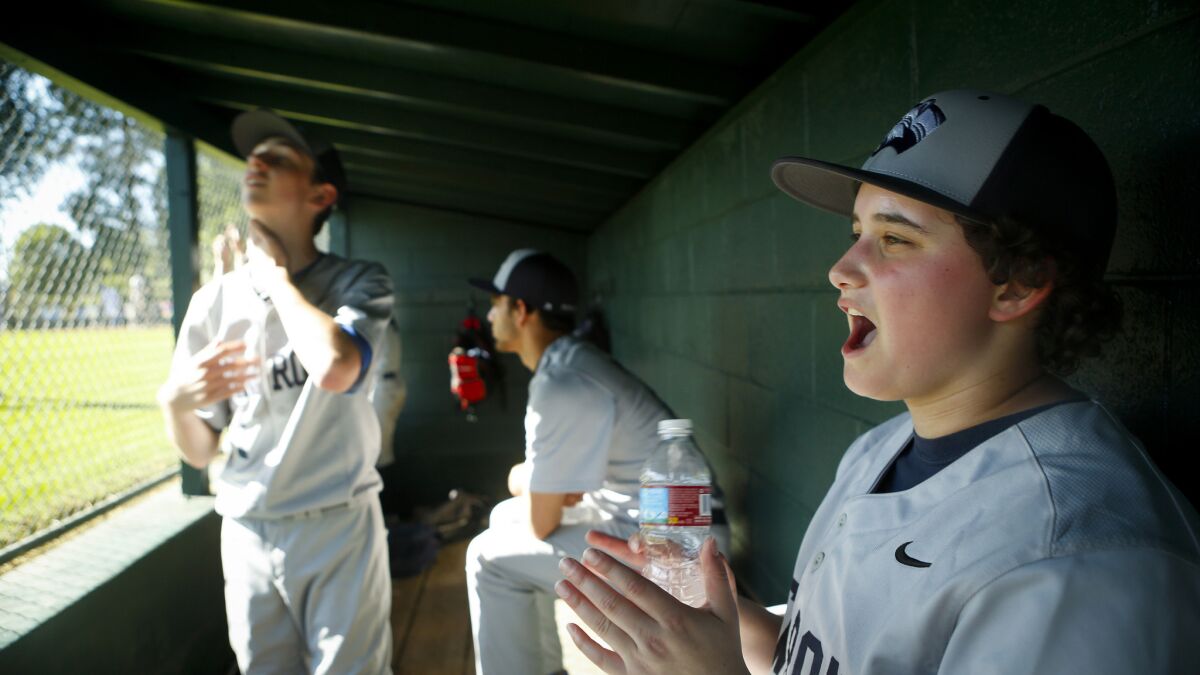 Jake Hofheimer cheers for his New Roads High baseball team during a game March 23