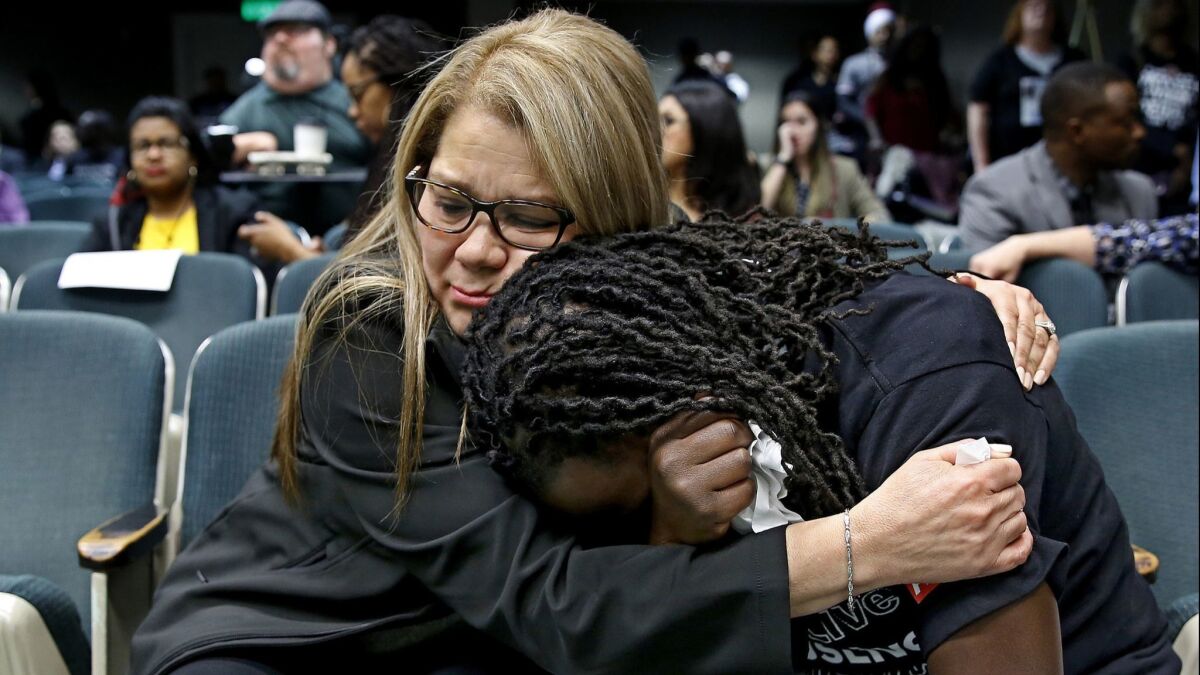 Elizabeth Medrano Escobedo, mother of Christian Escobedo, who was killed by Los Angeles police, comforts Ciara Hamilton, whose cousin Diante Yarber was killed by Barstow police, during a hearing to restrict police use of deadly force in Sacramento, Calif. on April 9.