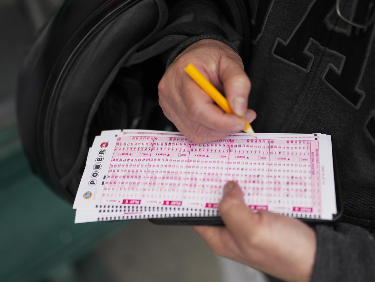 A person holds lottery tickets.