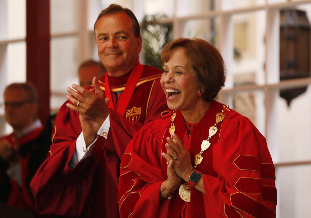 Dr. Carol L. Folt, right, celebrates with USC Board of Trustees Chair Rick J. Caruso after being bestowed the Presidential Medallion of Office.