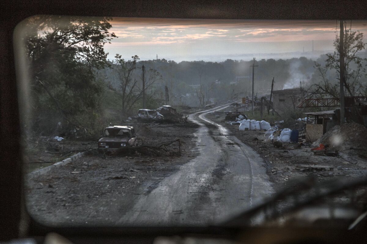 The gutted remains of cars sit along a road during heavy fighting at the front line in Severodonetsk in the Luhansk region of Ukraine, Wednesday, June 8, 2022. (AP Photo/Oleksandr Ratushniak)