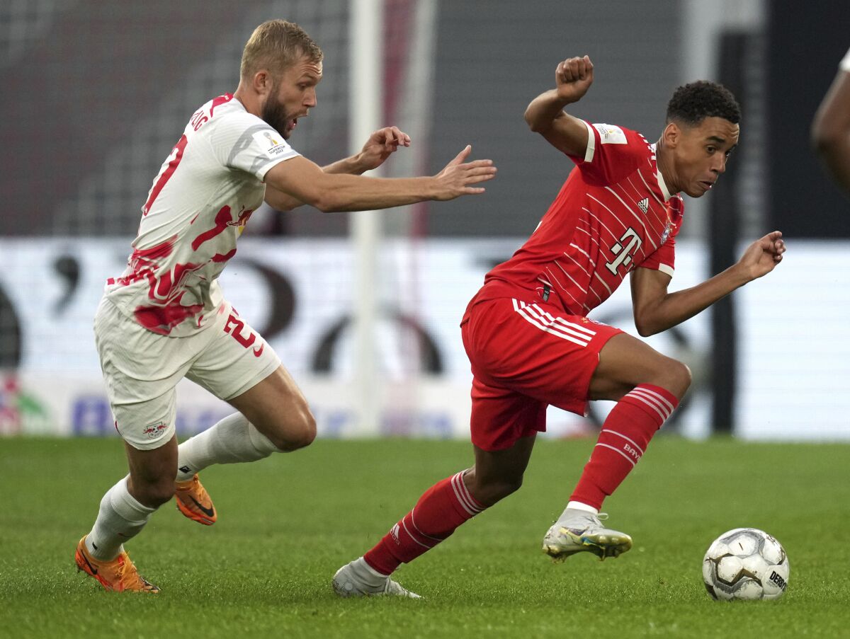 Leipzig's Konrad Laimer, left, and Bayern's Jamal Musiala, right, challenge for the ball