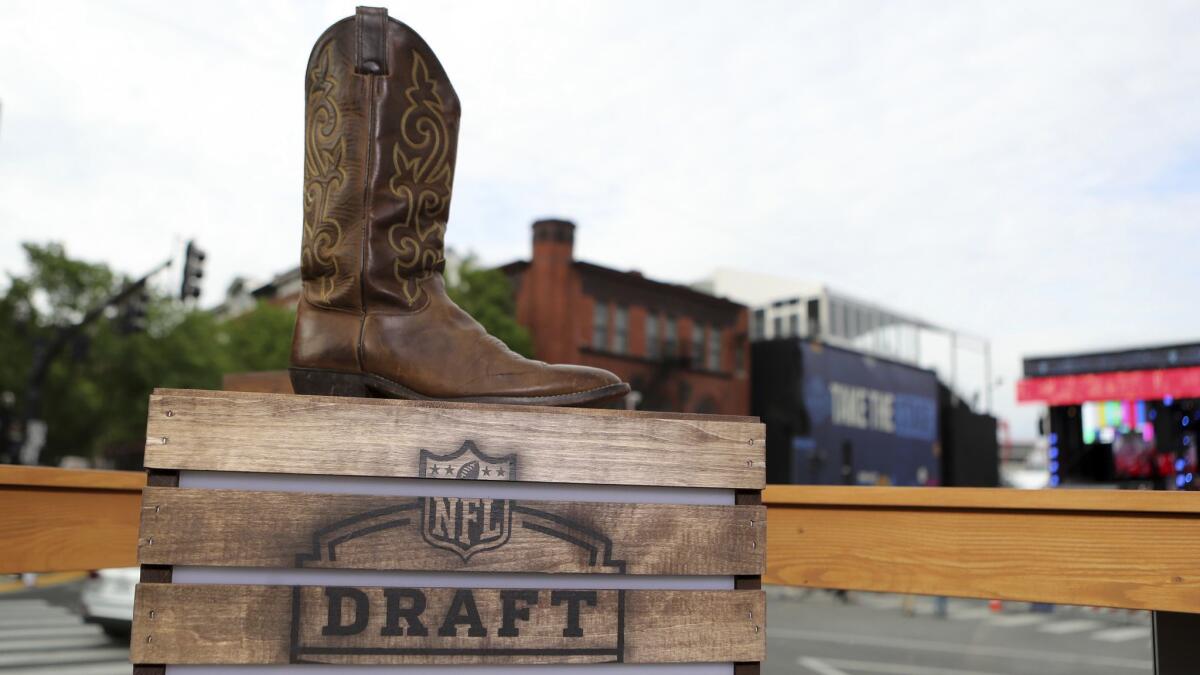 The logo for the 2019 NFL draft is seen with a cowboy boot in Nashville.