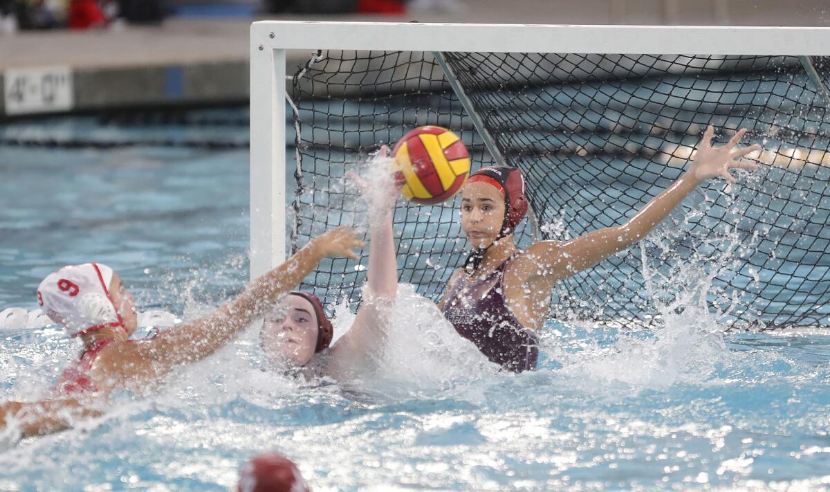 Laguna Beach goalie Lauren Schneider makes a save at close range on Mater Dei's Valerie Wraith (9).