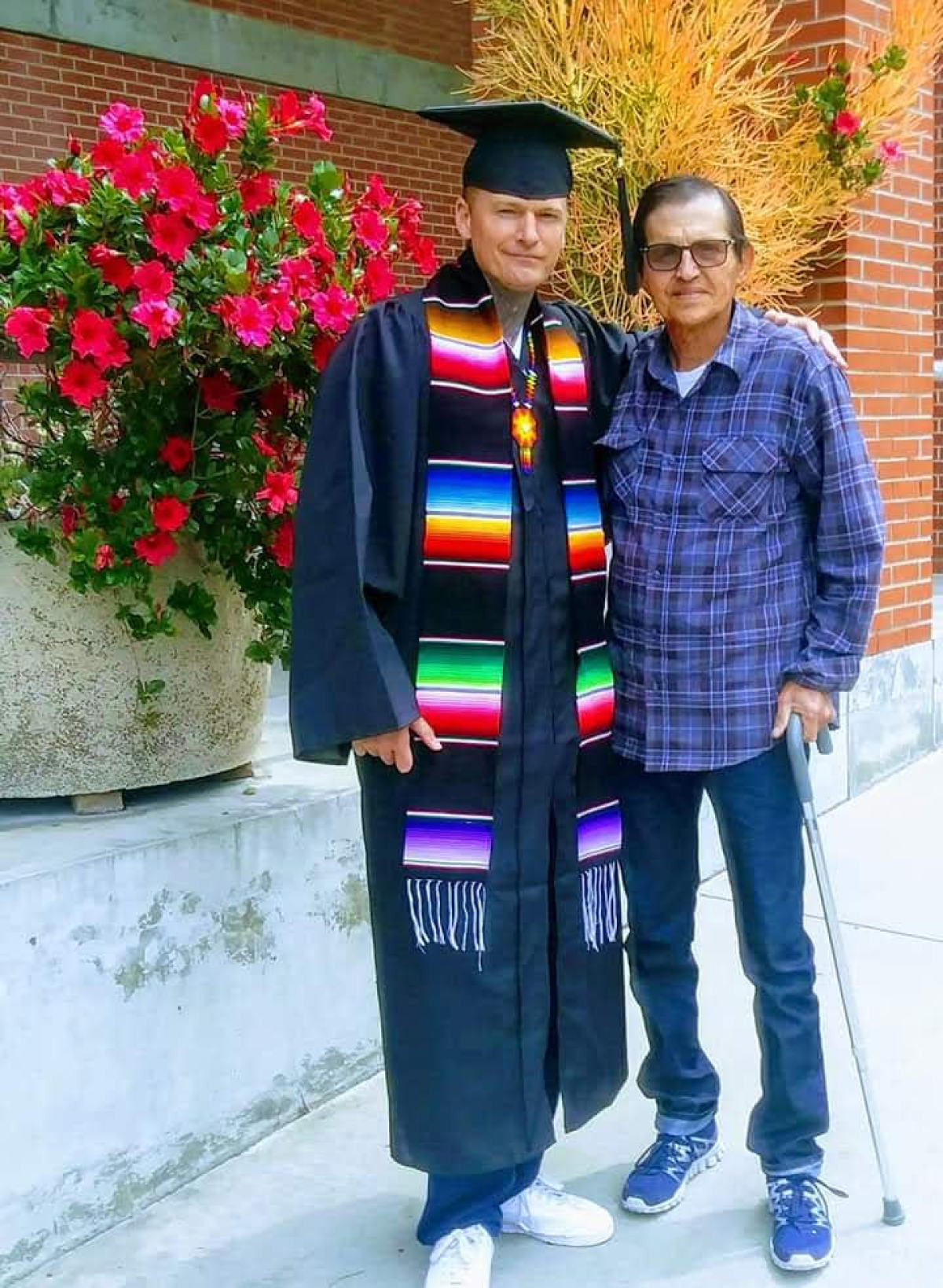 Ryan Rising with his dad at his graduation from San Diego City College in 2019.