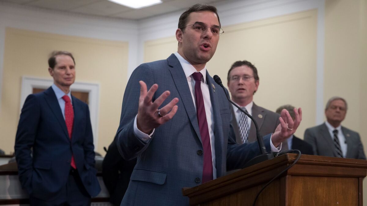 Rep. Justin Amash, R-Mich., center, is joined by, from left, Sen. Ron Wyden, D-Ore., Rep. Thomas Massie, R-Ky., and Rep. Ralph Norman, R-S.C., to discuss the FISA Amendments Reauthorization Act of 2017, in Washington on Jan. 10.