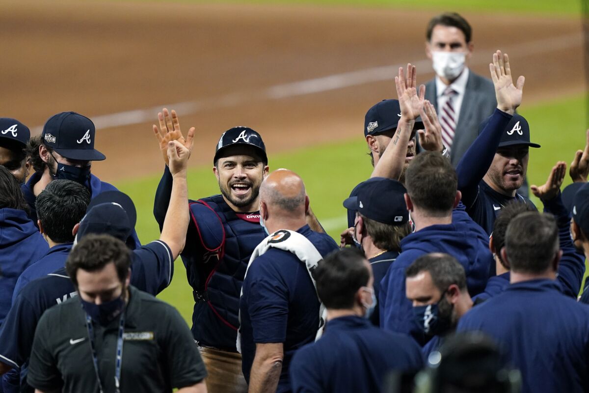 Atlanta catcher Travis d'Arnaud celebrates with teammates after the Braves defeated the Miami Marlins in Game 3 of their NLDS