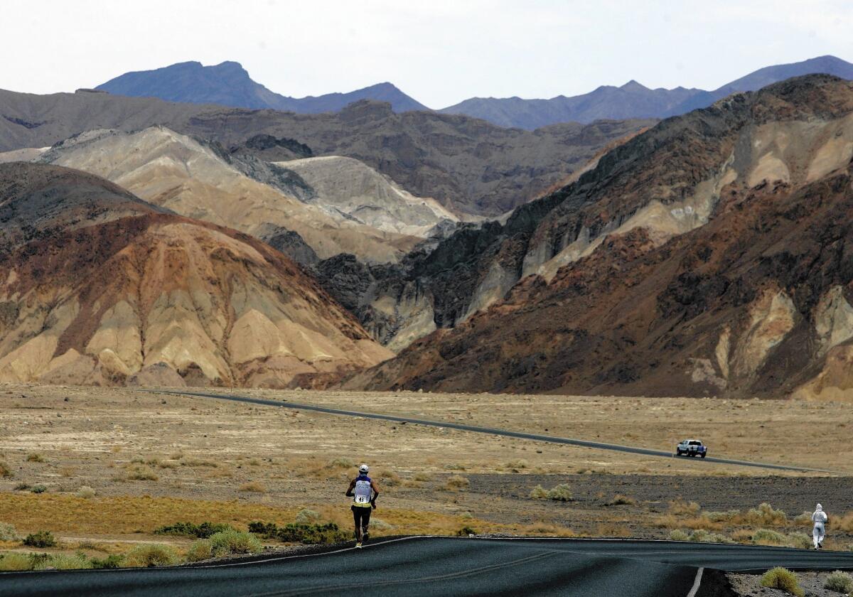 Participants in the Badwater Ultramarathon are seen running through Death Valley in the 2007 race. Death Valley National Park is putting the brakes on ultramarathons and other extreme sports events that involve running and cycling until rangers can determine how safe it is to hold those competitions in a place that records the hottest temperatures on Earth.