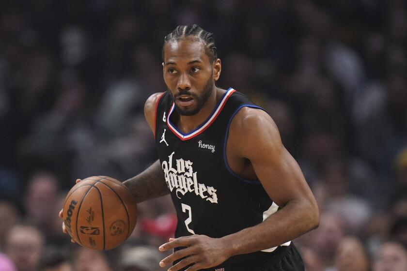 Los Angeles Clippers' Kawhi Leonard dribbles during the first half of an NBA basketball game against the Golden State Warriors Friday, March 17, 2023, in Los Angeles. (AP Photo/Jae C. Hong)