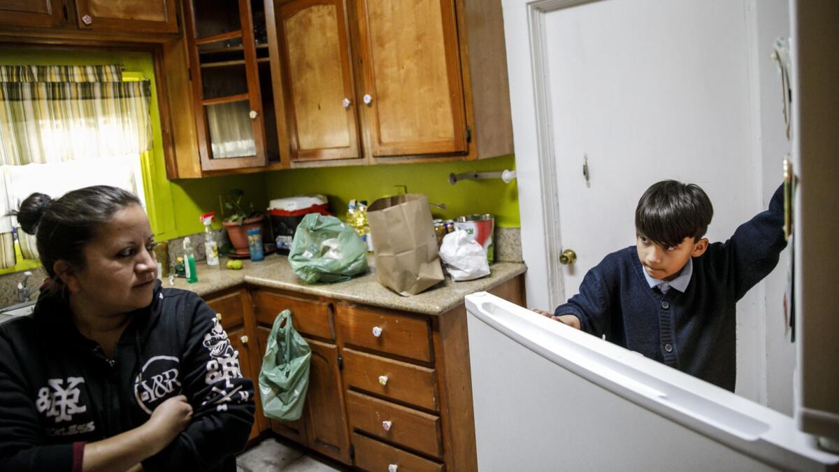 With extra-curricular activities at school canceled Monday, Merwinn Rojas, 11, sits idle at home, in Los Angeles.