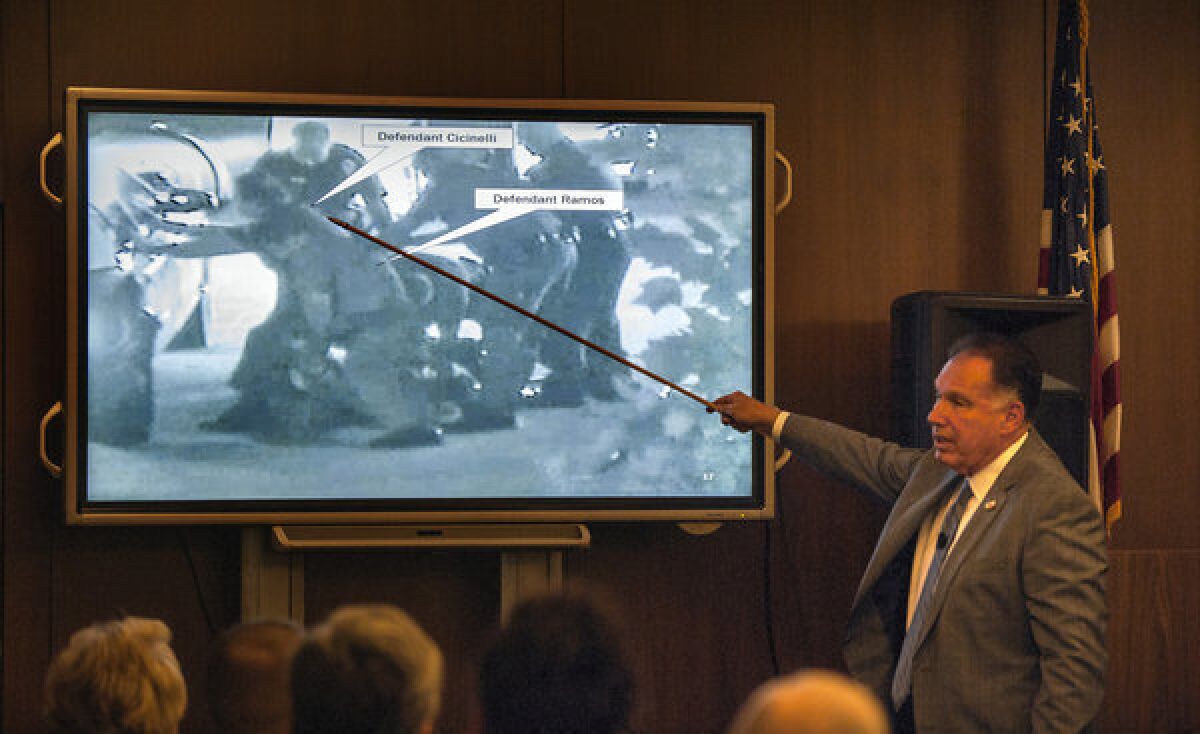 Orange County Dist. Atty. Tony Rackauckas shows the jury an image of police trying to subdue Kelly Thomas on July 5, 2011, during the trial of former Fullerton officers Manuel Ramos and Jay Cicinelli.