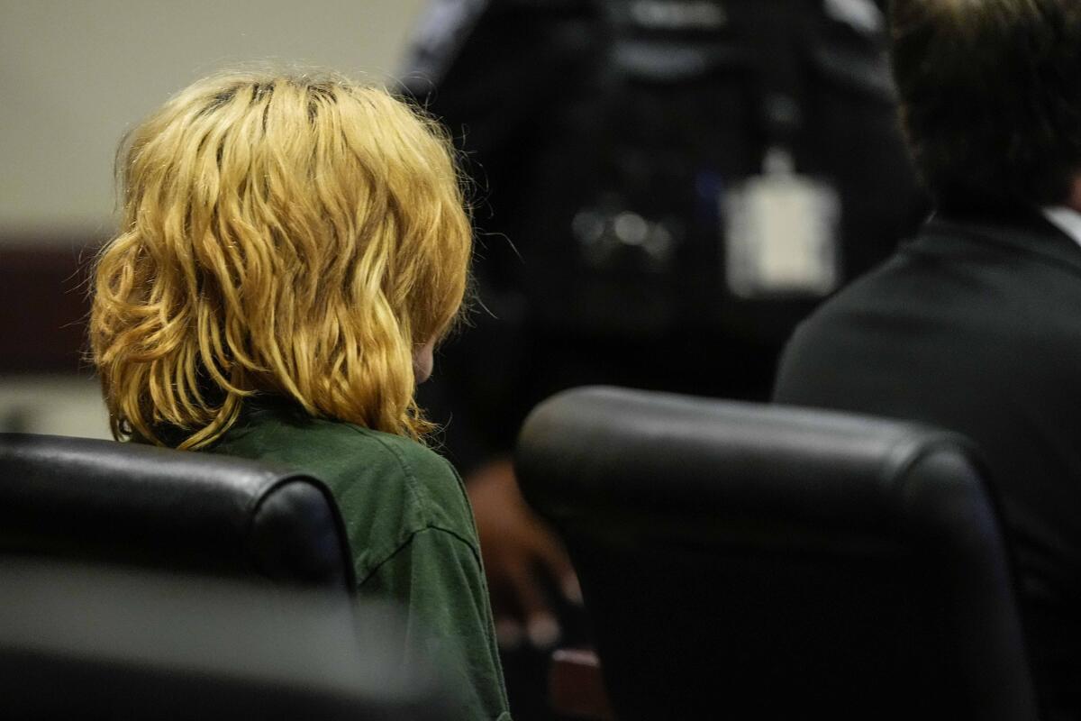 A 14-year-old suspect sits in court. 