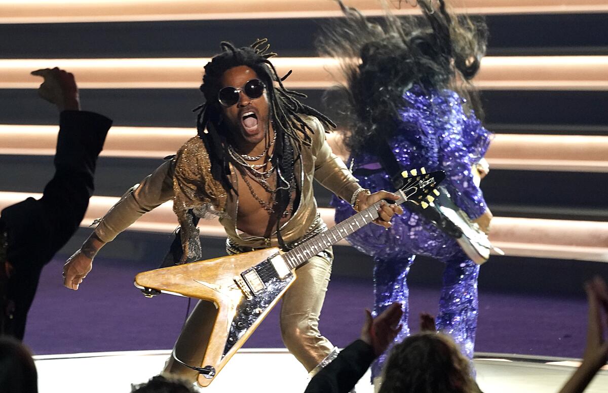 Lenny Kravitz, left, and H.E.R. perform "Are you Gonna Go My Way" at the 64th Annual Grammy Awards.