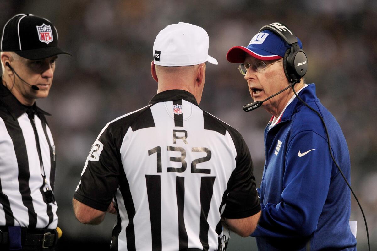 New York Giants Coach Tom Coughlin talks with referee John Parry during a preseason game on Aug. 22.