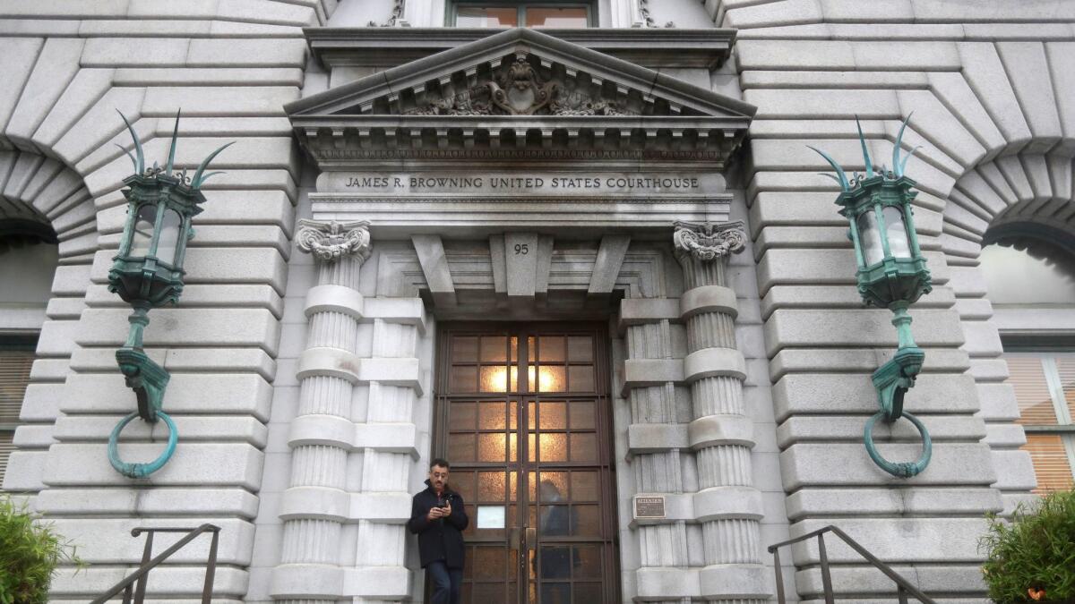 A man stands outside the main door outside the 9th U.S. Circuit Court of Appeals building in San Francisco on Feb. 15.