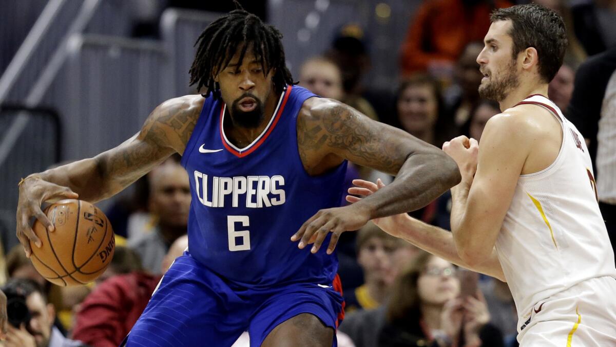 Clippers DeAndre Jordan works in the post against Cleveland's Kevin Love during the first half Friday night.