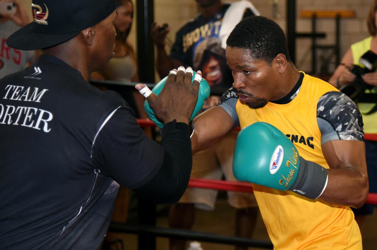 Shawn Porter, right, spars with father and trainer Kenneth Porter on Aug. 6, 2014.