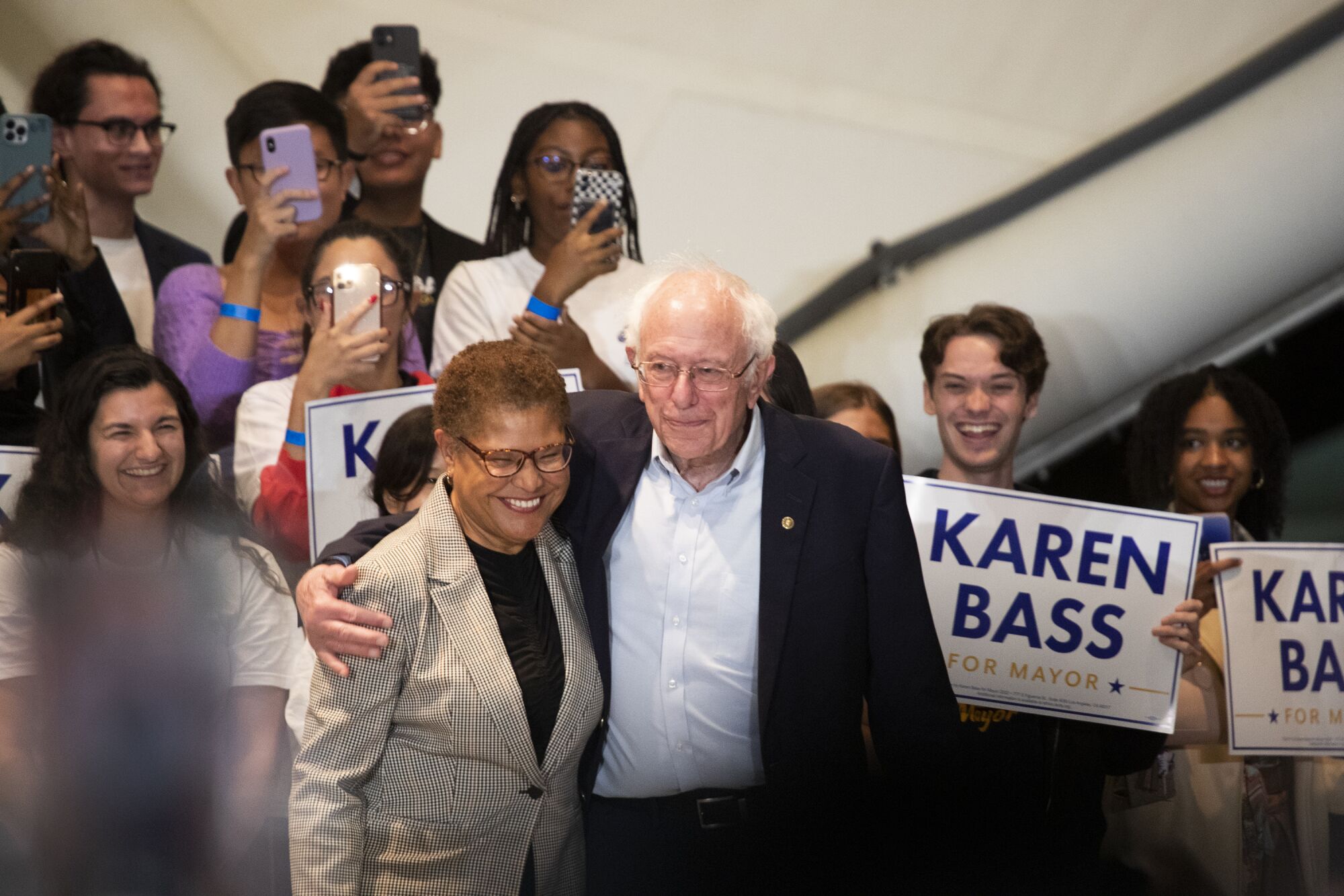 Sen. Bernie Sanders hugs Rep. Karen Bass before speaking at her campaign rally.