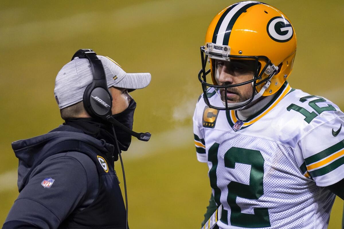 Green Bay Packers head coach Matt LaFleur talks to Aaron Rodgers.