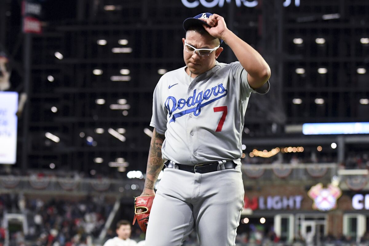 Dodgers pitcher Julio Urías walks off the field after giving up two runs in the eighth inning.