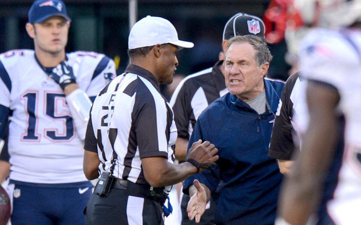Patrits Coach Bill Belichick argues an unsportsmanlike conduct penalty on a Jets field-goal attempt in overtime Sunday.