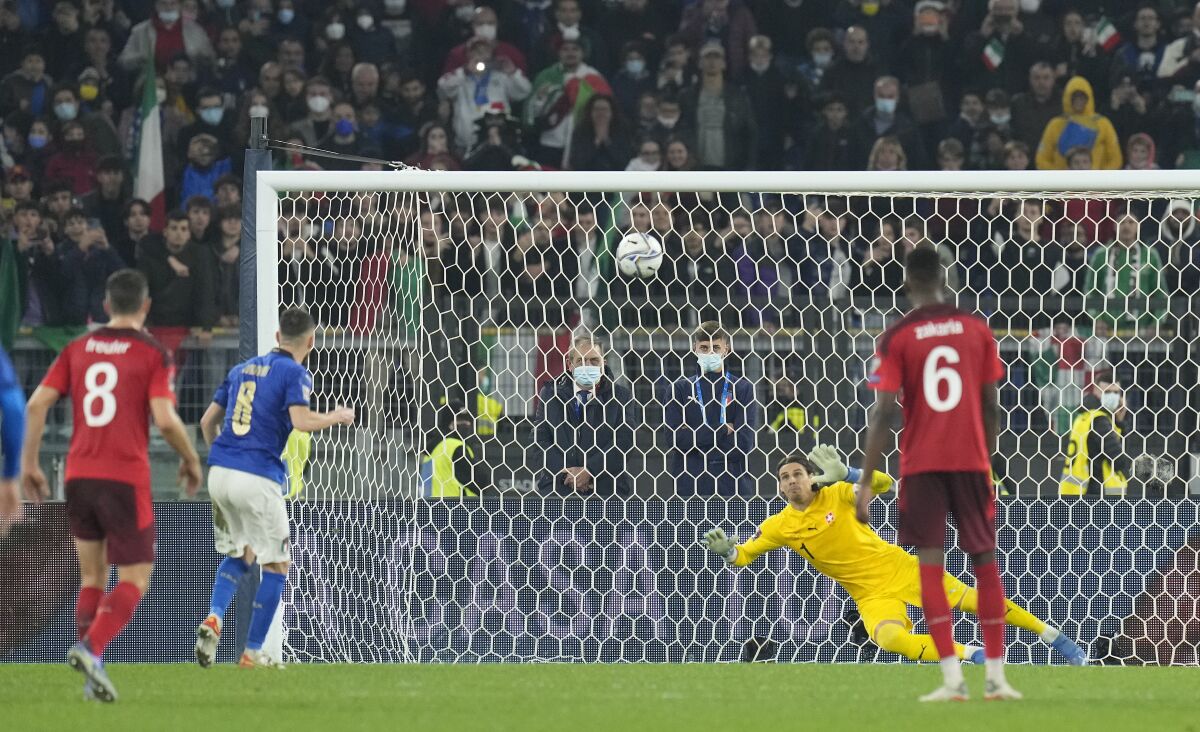 Italy's Jorginho, second left, blasts the ball over the bar to miss a penalty during the World Cup 2022 group C qualifying soccer match between Italy and Switzerland at Rome's Olympic stadium, Friday, Nov. 12, 2021. (AP Photo/Gregorio Borgia)