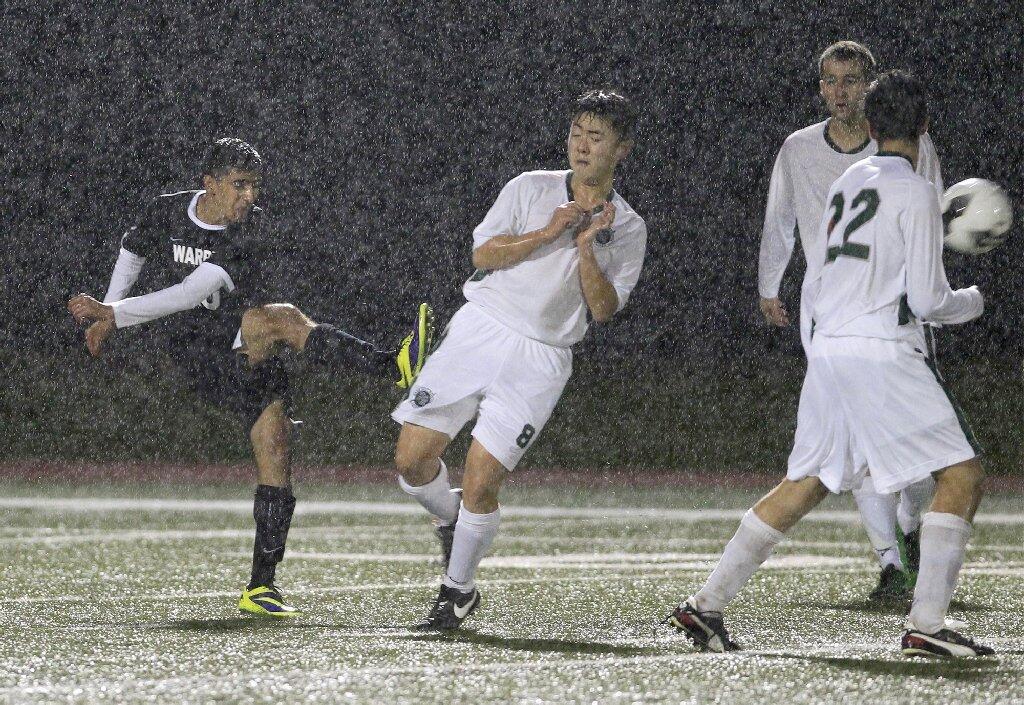 Brethren Christian's Ebram Gerges, far left, kicks the ball up field against Sage Hill's Danny Lee, center, during the second half in an Academy League game on Thursday.