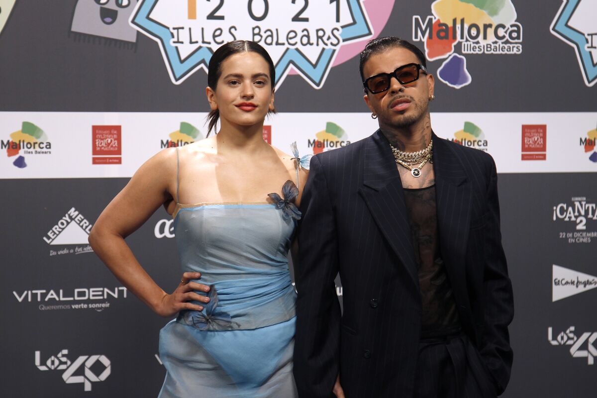 Rosalía and Rauw Alejandro pose together at an awards show. 