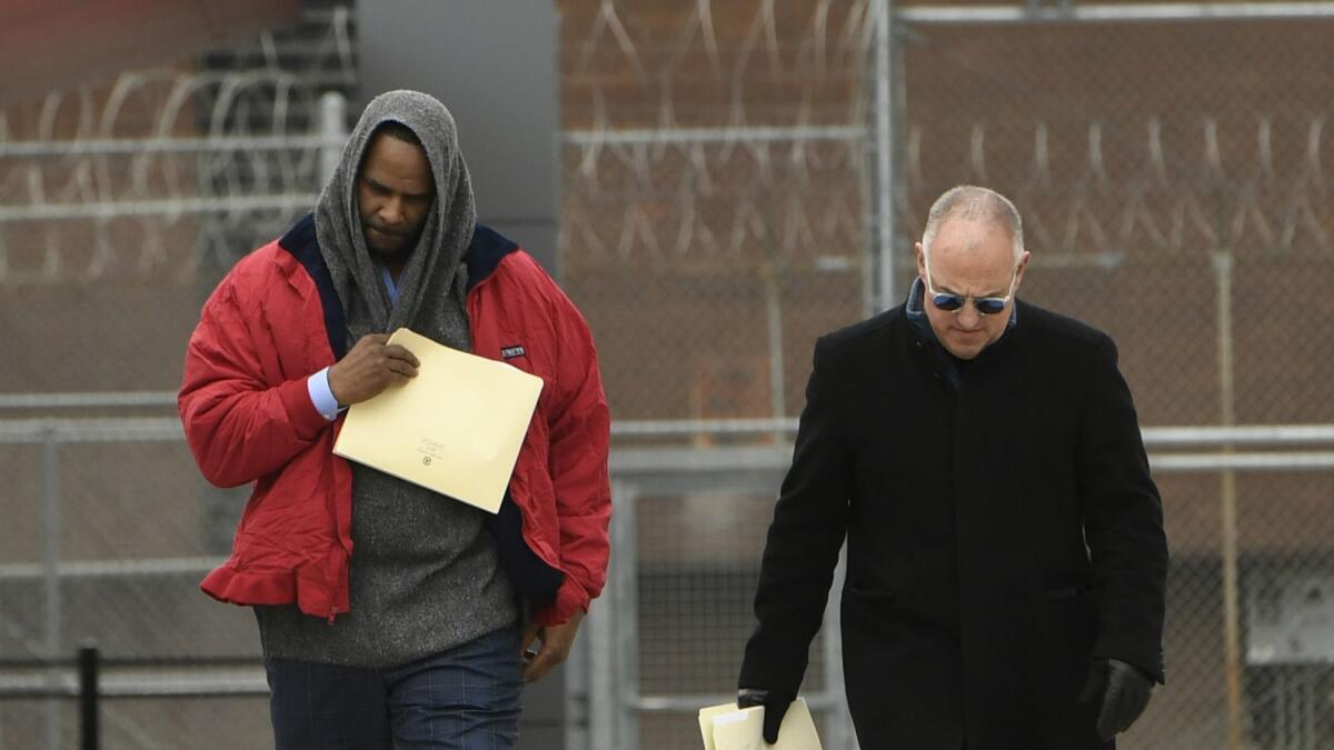 Singer R. Kelly, left, walks with his attorney Steve Greenberg after being released from Cook County Jail in Chicago on Saturday.