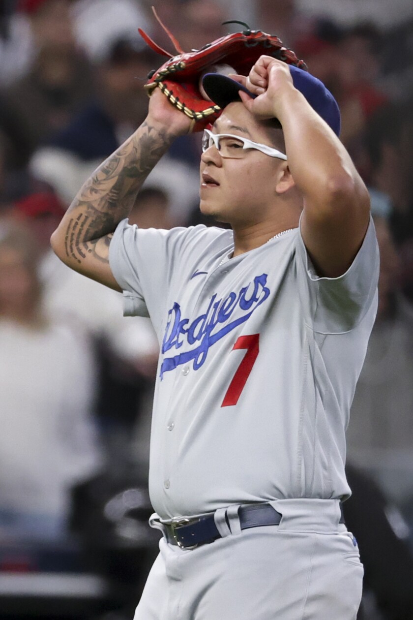 Dodgers pitcher Julio Urias reacts after giving up a run-scoring single to Atlanta's Ozzie Albies.