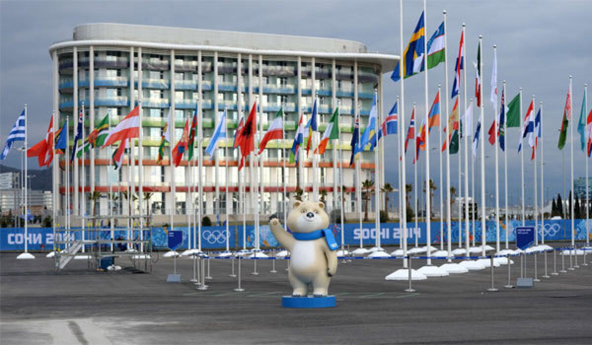 International flags fly near one of the official mascots of the 2014 Winter Olympics on Wednesday at the Amphitheatre Square in Sochi.