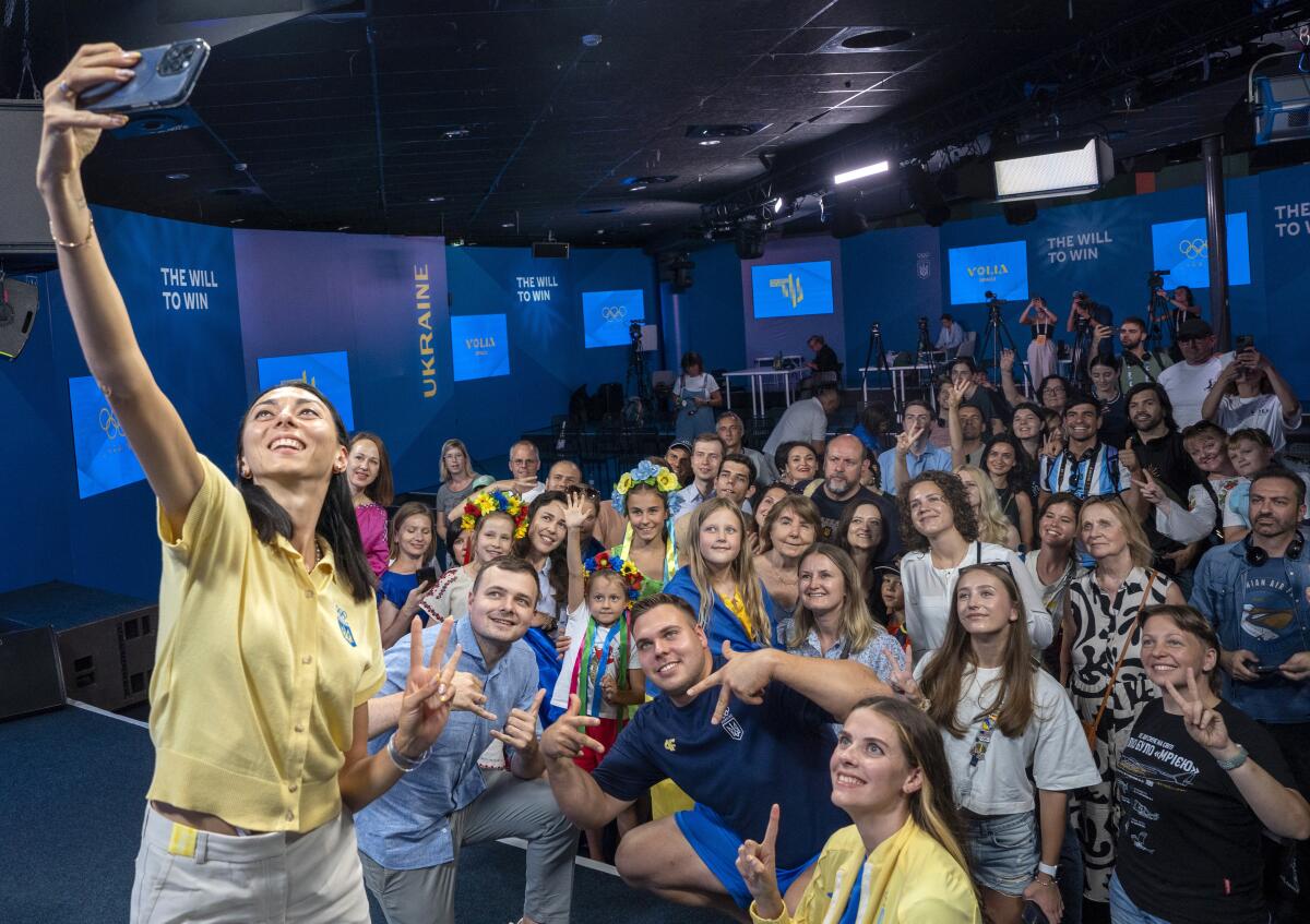 Ukrainian bronze medalist high jumper Iryna Gerashchenko takes a group selfie.