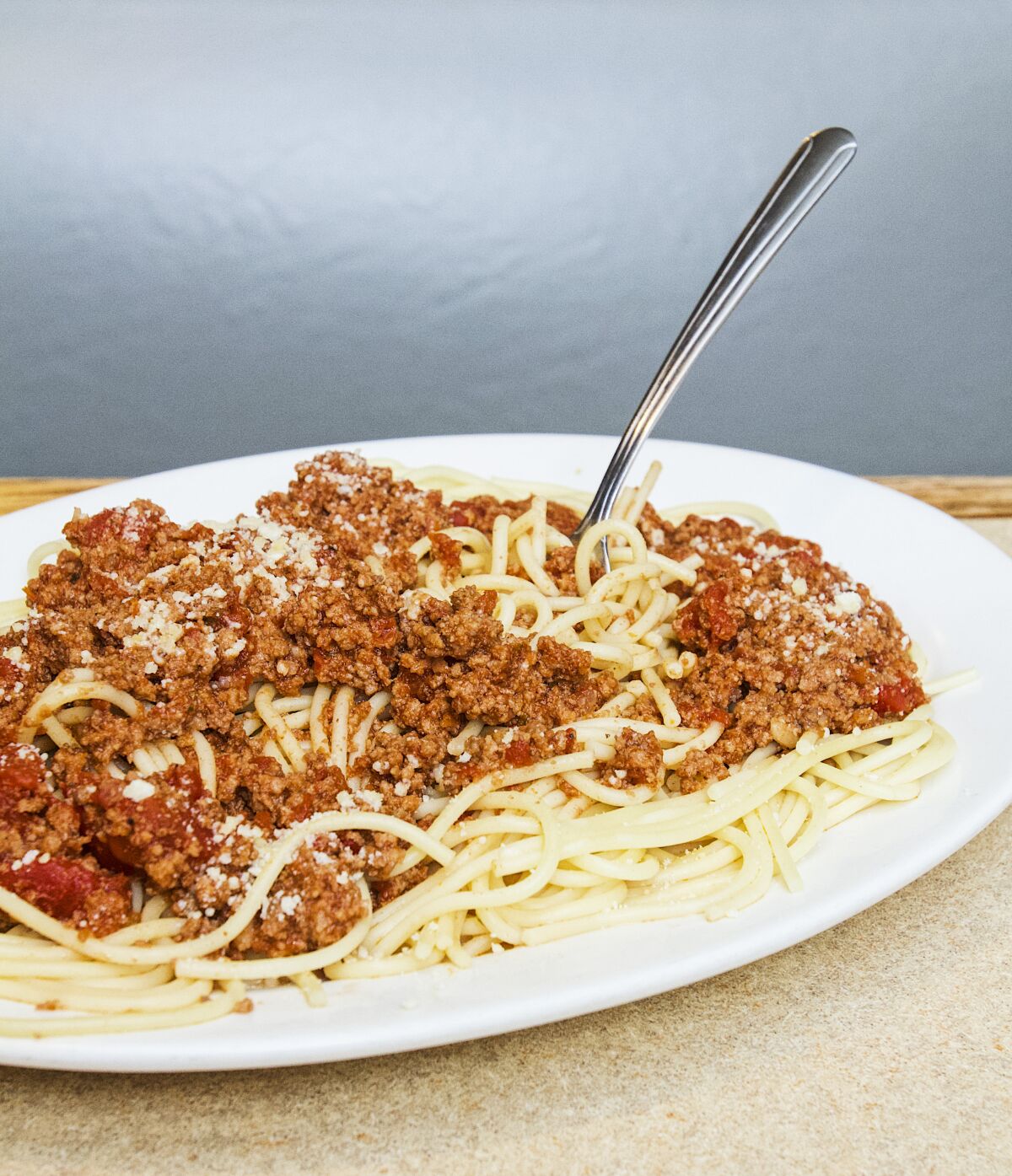 A photo of the spaghetti at Rick's Drive In & Out, with a fork sticking out from the side of it.