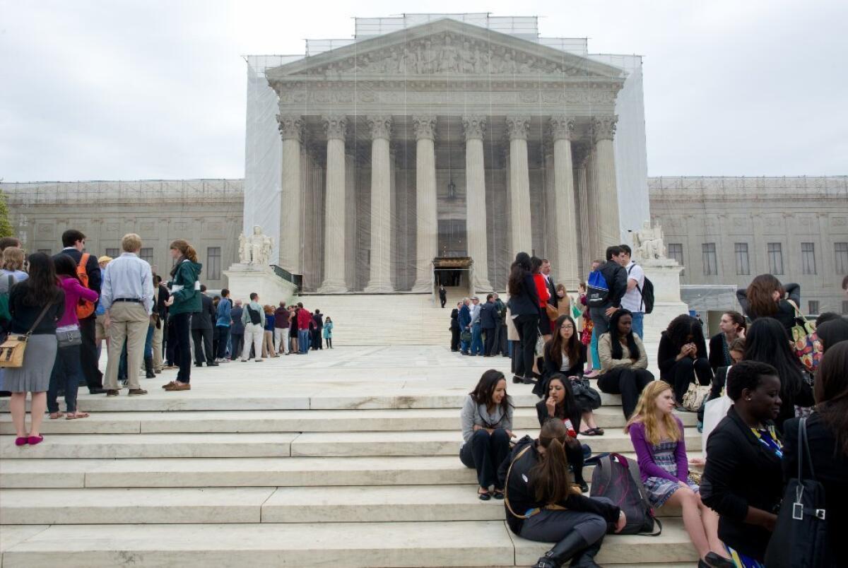 Crowds wait outside the Supreme Court as the justices prepared to hear arguments in the case against Myriad Genetics, which holds several patents on human genes.