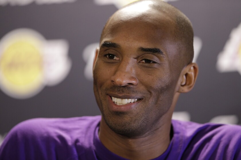 FILE - Los Angeles Lakers' Kobe Bryant speaks with members of the media ahead of a basketball game against the Philadelphia 76ers in Philadelphia, in this Tuesday, Dec. 1, 2015, file photo. Kobe Bryant, Tim Duncan and Kevin Garnett. Each was an NBA champion, an MVP, an Olympic gold medalist, annual locks for All-Star and All-Defensive teams. And now, the ultimate honor comes their way: On Saturday night, May 15, 2021, in Uncasville, Connecticut, they all officially become members of the Naismith Memorial Basketball Hall of Fame. (AP Photo/Matt Rourke, File)