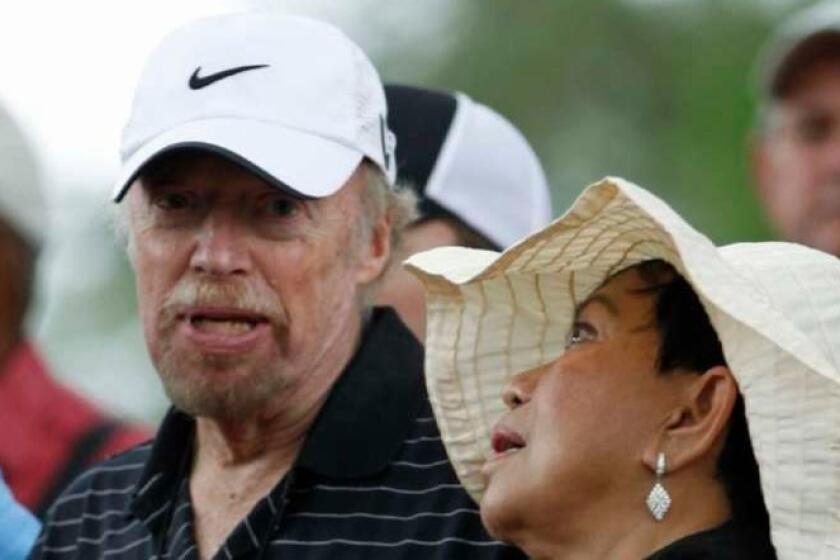 Tiger Woods' mother, Kultida Woods, chats with Nike co-founder Phil Knight during the first round of the Masters golf tournament in Augusta, Ga., Thursday, April 8, 2010. (AP Photo/Morry Gash) ORG XMIT: NGM_0L0KX9GV