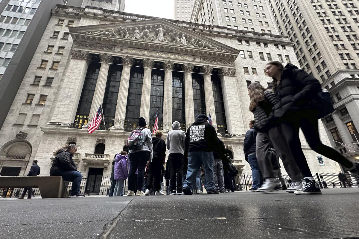 People walk past the New York Stock Exchange 