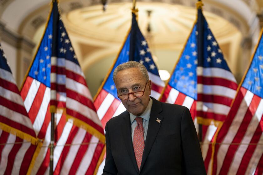 WASHINGTON, DC - JUNE 07: Senate Majority Leader Chuck Schumer (D-NY) speaks to an aide during a news conference following policy luncheons on Capitol Hill on Tuesday, June 7, 2022 in Washington, DC. (Kent Nishimura / Los Angeles Times)