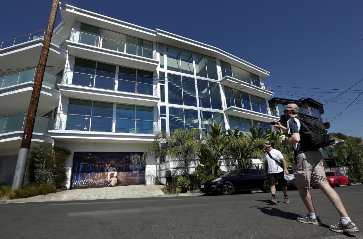 The Los Angeles city attorney has filed charges against the owner and manager of two Hollywood Hills properties known for being locales for partying. Pictured above is a home on Weidlake Drive that drew similar scrutiny in 2015.