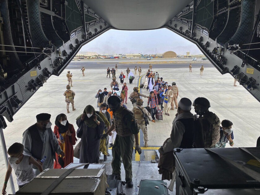 People board a plane at Kabul's international airport.