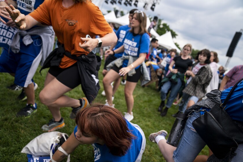 WASHINGTON, DC - JUNE 11: People panic and run after a man charged the main stage at the March for Our Lives rally on the National Mall near the Washington Monument on Saturday, June 11, 2022 in Washington, DC. (Kent Nishimura / Los Angeles Times)