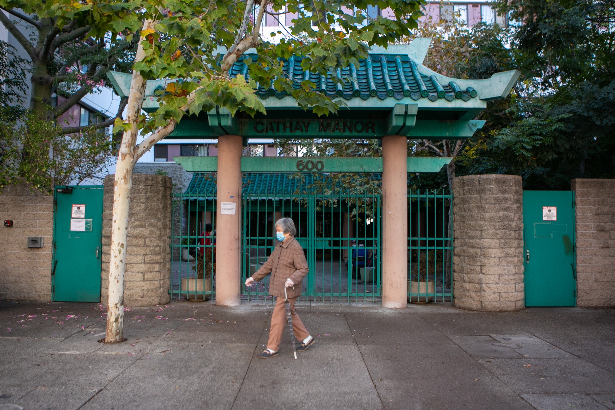 A woman exits Cathay Manor in Chinatown.