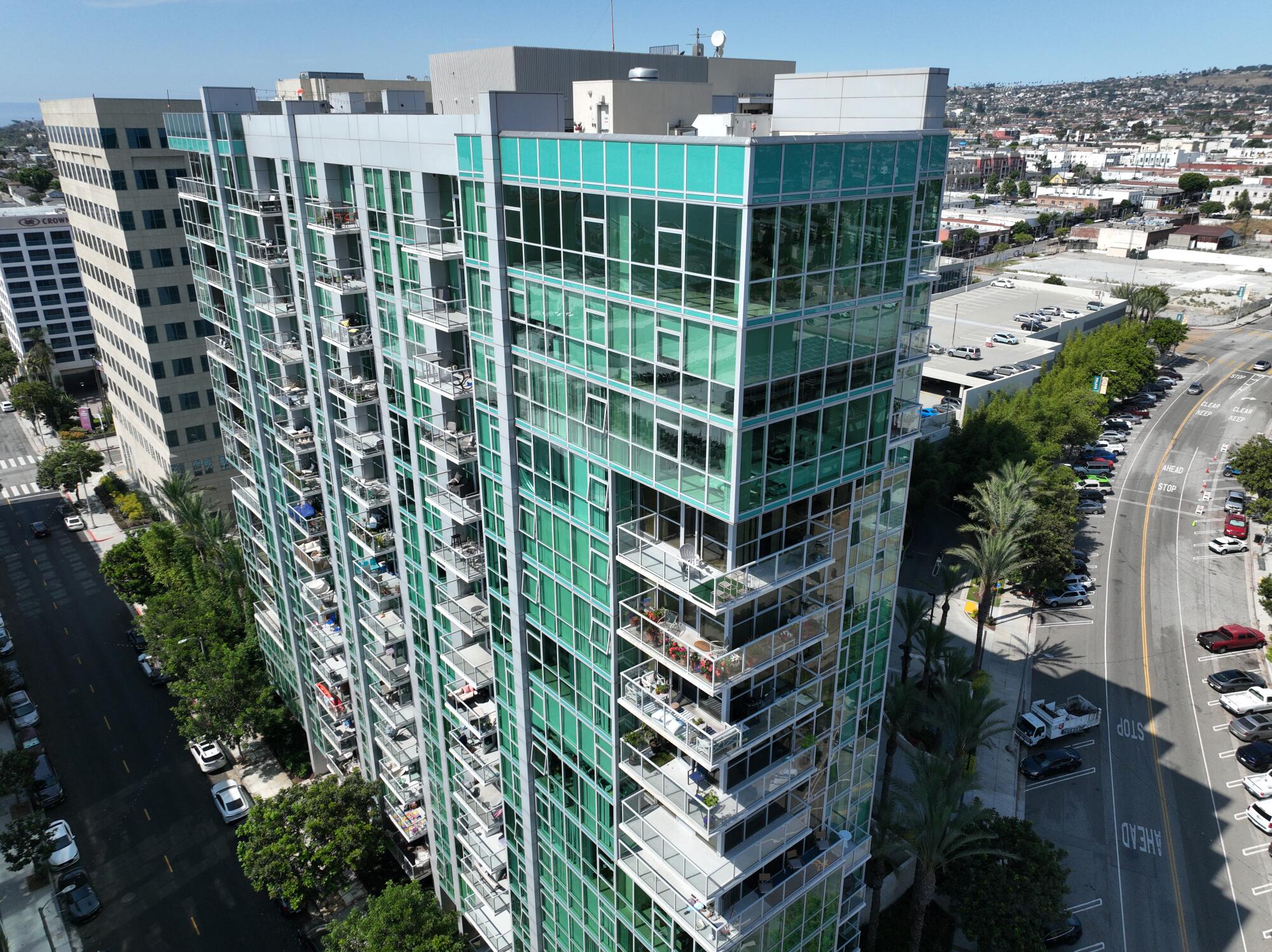 A bluish-green high-rise residential building.