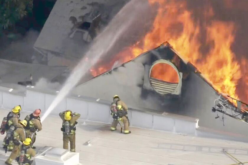 Firefighters put out a fire at the former Hollywood Playhouse Theater on June 13. 