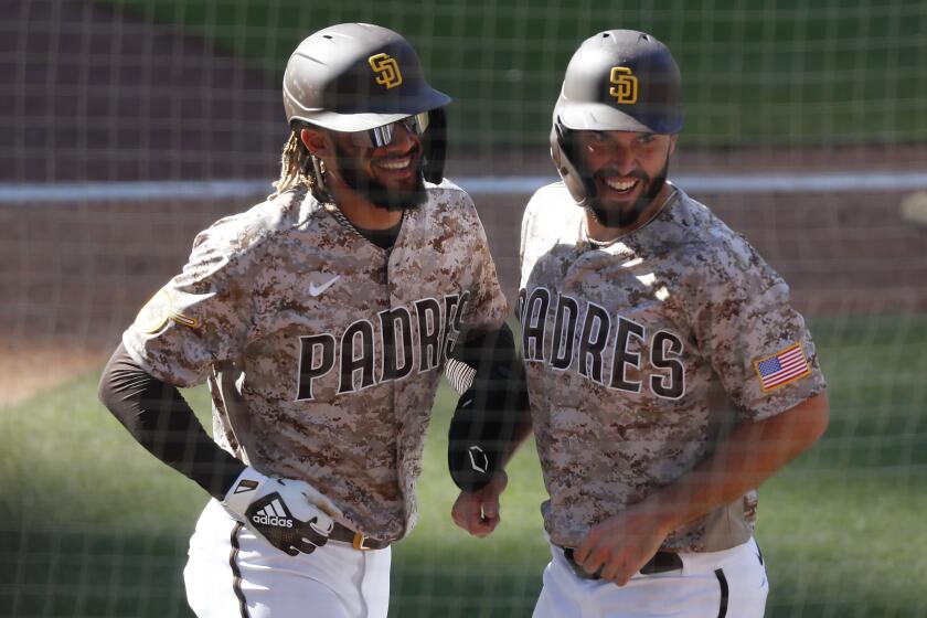 Yu Darvish stands in the dugout of the San Diego Padres before the