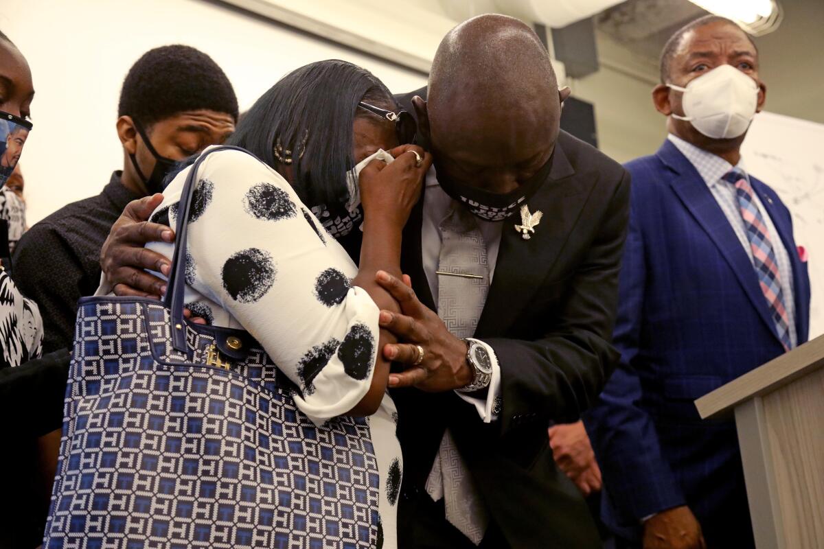 Family members cry during a news conference