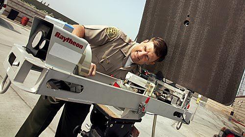 Charles Sid Heal of the L.A. County Sheriff's Department takes a look at Raytheon's "Silent Guardian," a non-lethal device that stimulates pain sensors without damaging tissue. As head of the Technology Exploration Unit for the last decade, Heal has tested hundreds of such high-tech gizmos -- sometimes using himself as the guinea pig.