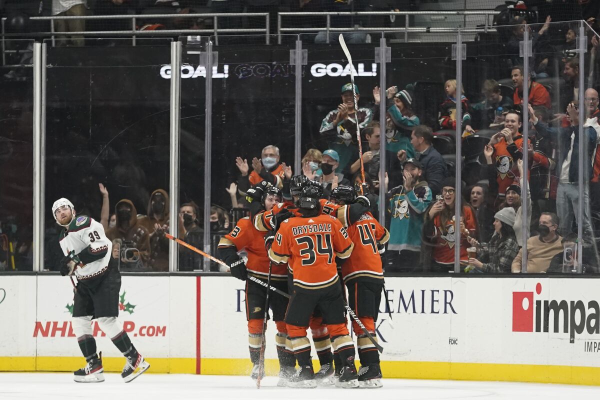 The Ducks, right, celebrate after defenseman Hampus Lindholm (47) scored a goal during the first period.