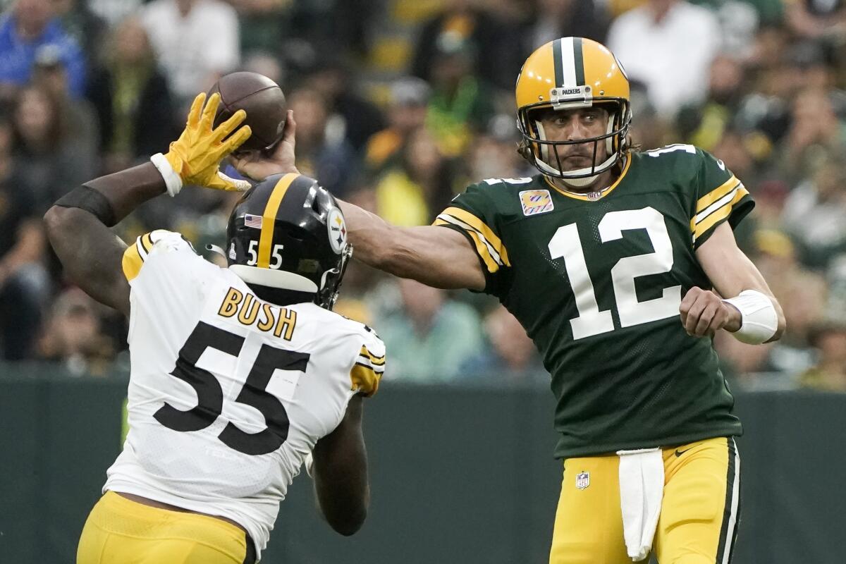 Green Bay Packers quarterback Aaron Rodgers throws past Pittsburgh Steelers linebacker Devin Bush.