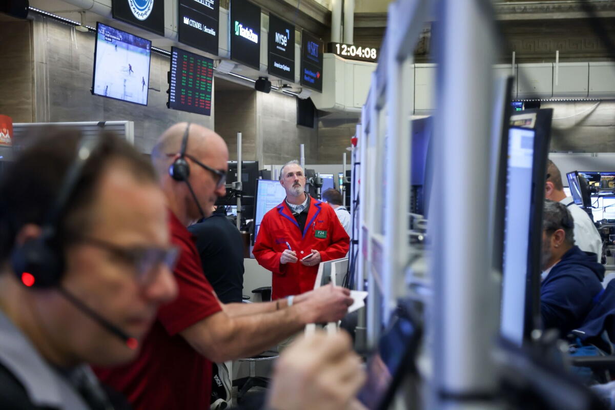 Traders work at the New York Stock Exchange.